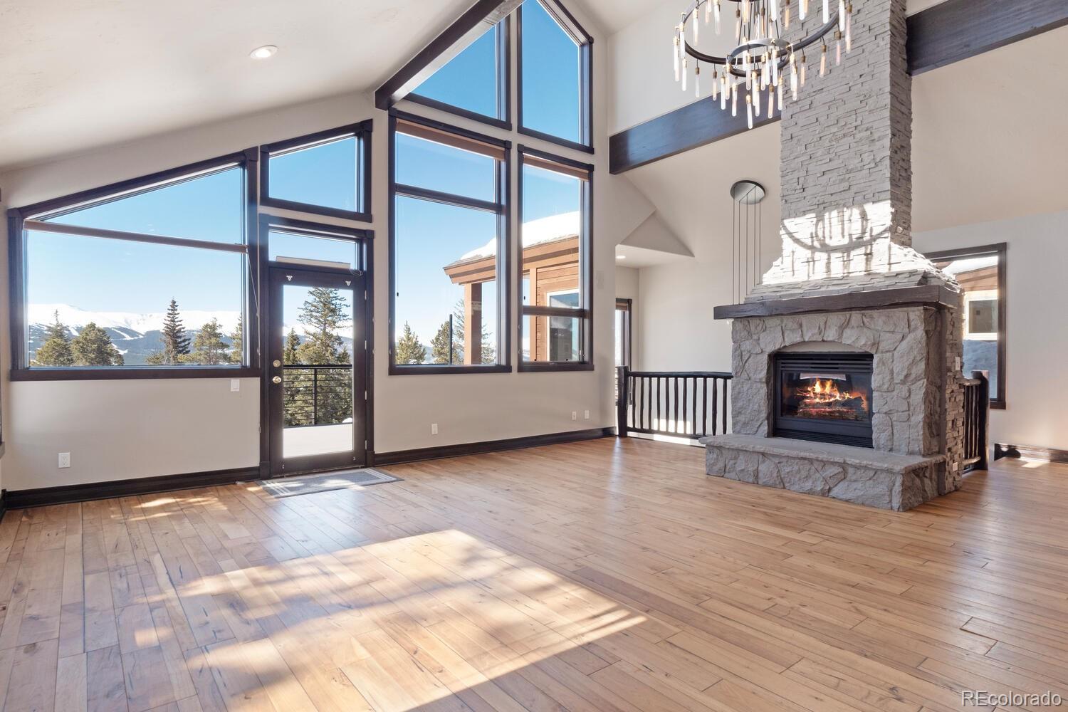 160 Fuller Placer Road Breckenridge, CO 80424 - Photo 12 of 47 a view of an empty room with a fireplace and wooden floor