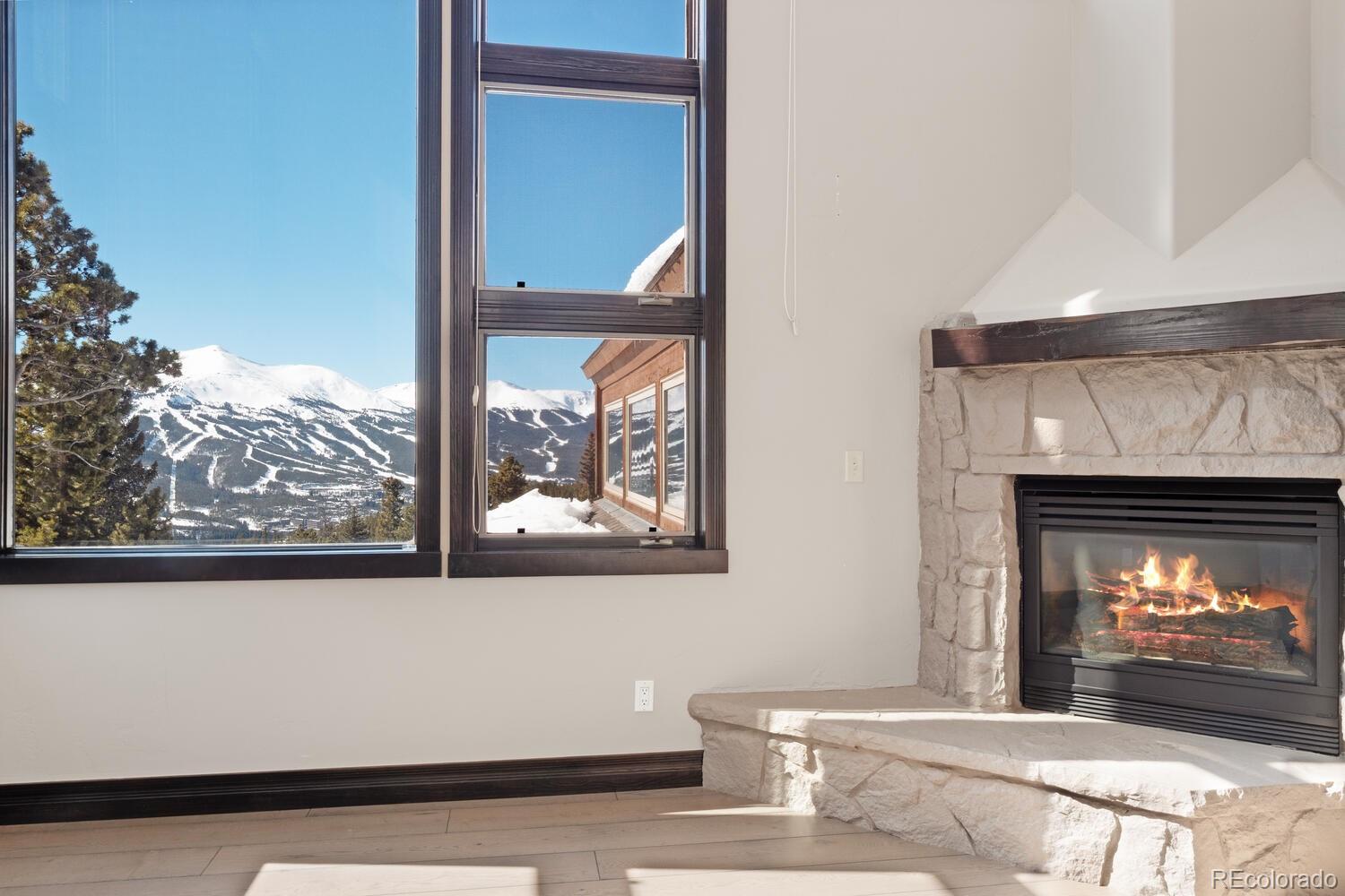 160 Fuller Placer Road Breckenridge, CO 80424 - Photo 14 of 47 a view of a living room that has a fireplace and a large window