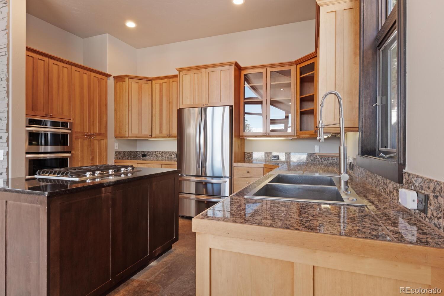 160 Fuller Placer Road Breckenridge, CO 80424 - Photo 18 of 47 a kitchen with stainless steel appliances granite countertop a refrigerator and a sink