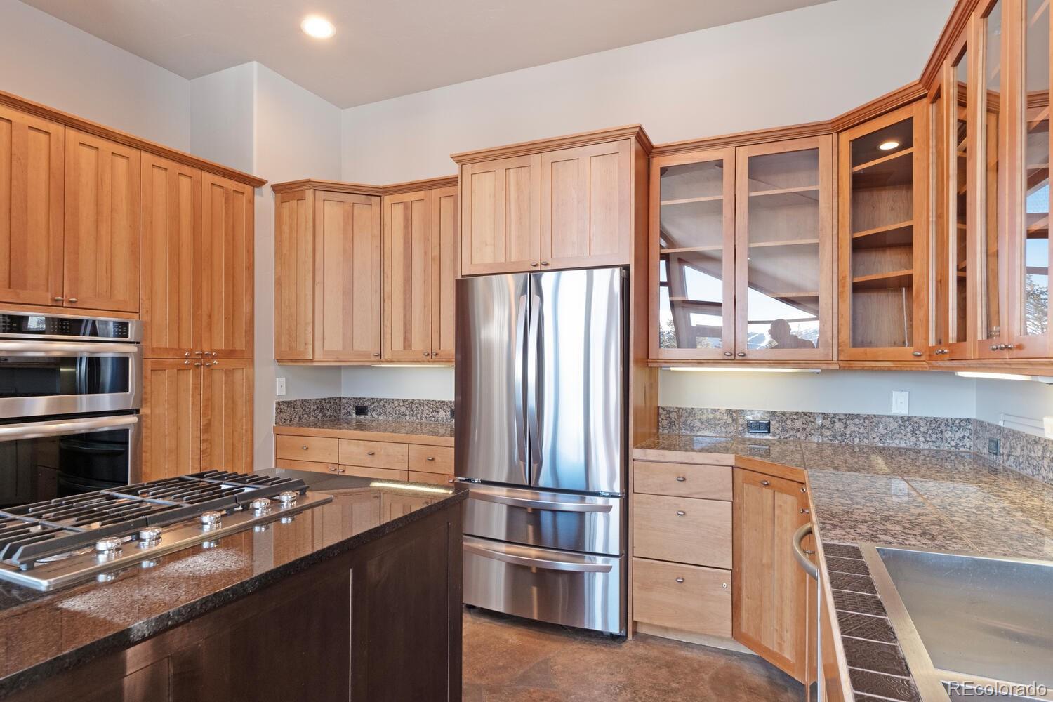 160 Fuller Placer Road Breckenridge, CO 80424 - Photo 19 of 47 a kitchen with kitchen island granite countertop a sink stove and refrigerator