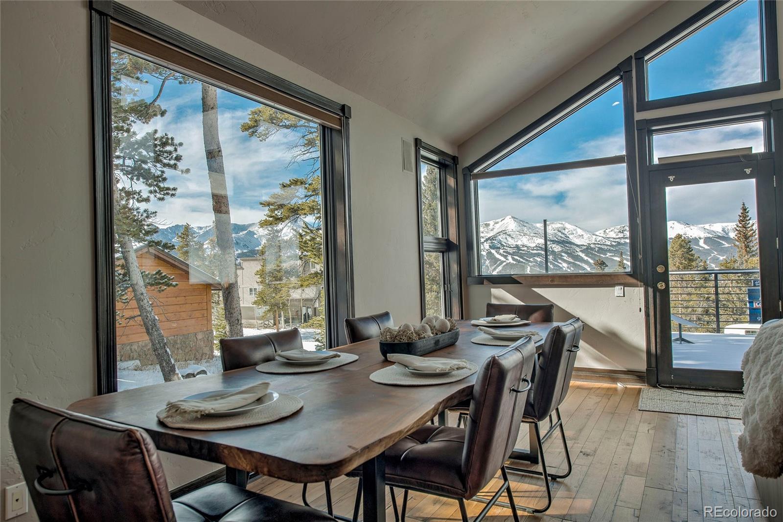 160 Fuller Placer Road Breckenridge, CO 80424 - Photo 21 of 47 a view of a dining room with furniture large windows and wooden floor