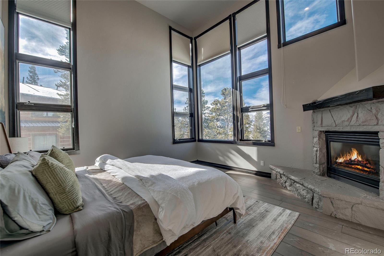 160 Fuller Placer Road Breckenridge, CO 80424 - Photo 26 of 47 a bedroom with a bed and a fireplace next to a window
