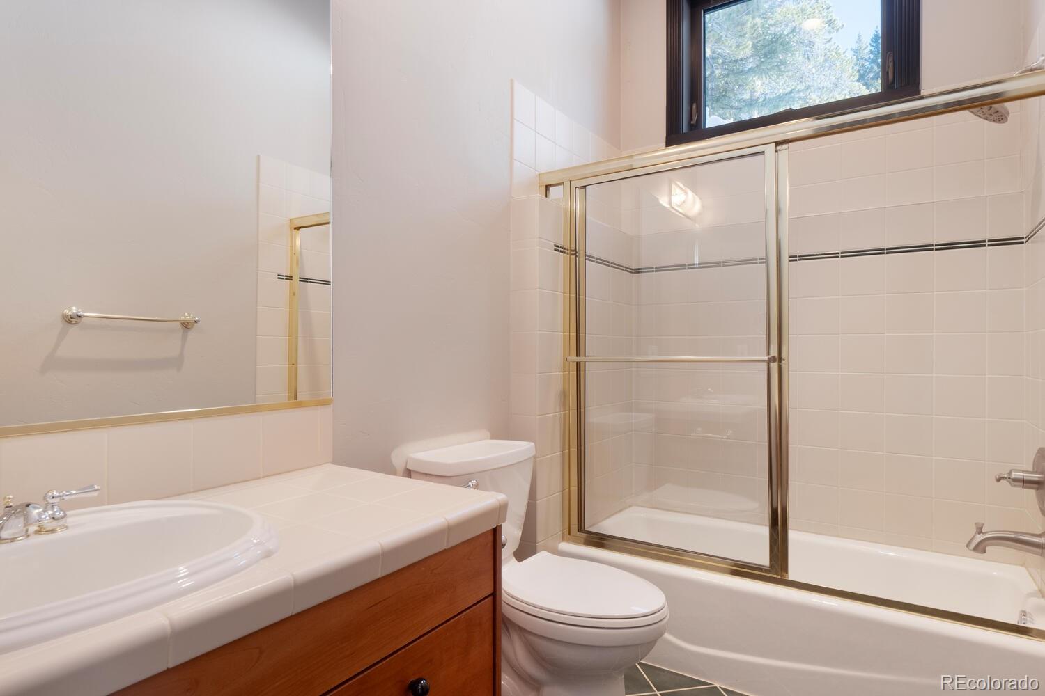 160 Fuller Placer Road Breckenridge, CO 80424 - Photo 35 of 47 a bathroom with a sink a toilet and shower