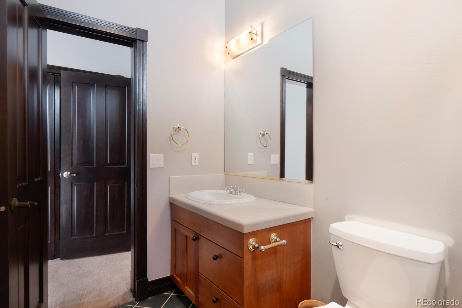 160 Fuller Placer Road Breckenridge, CO 80424 - Photo 36 of 47 a bathroom with a sink a toilet and shower