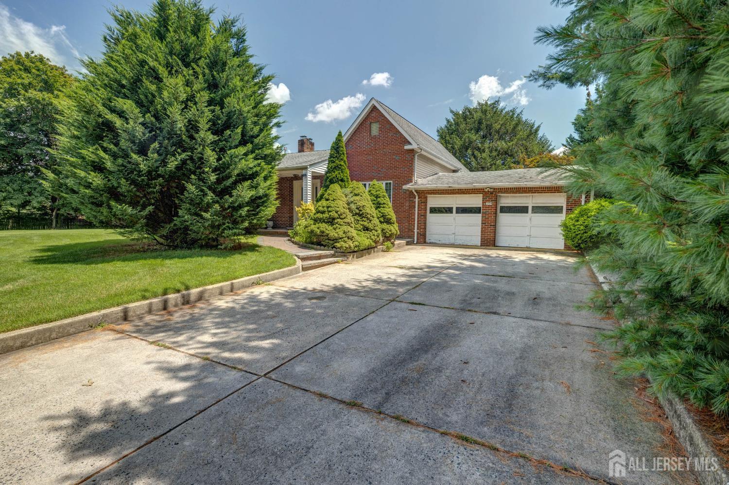 294 Fresh Ponds Road North Brunswick, NJ 08902 - Photo 1 of 53 a view of a house with a yard and large tree