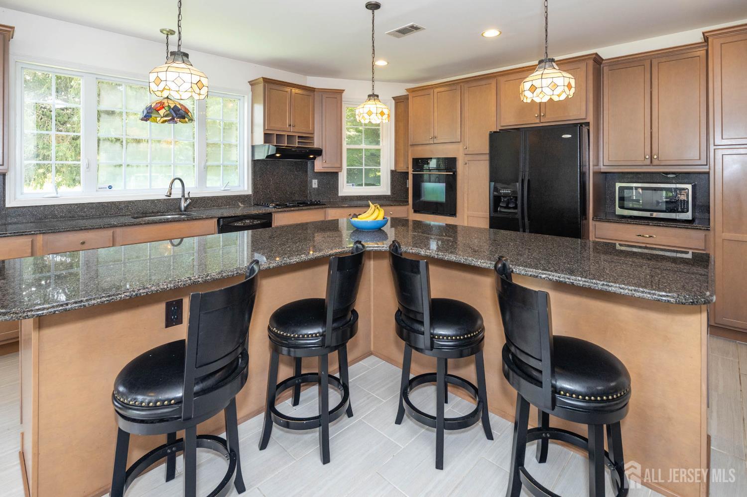 294 Fresh Ponds Road North Brunswick, NJ 08902 - Photo 14 of 53 a kitchen with granite countertop stainless steel appliances a table chairs sink refrigerator and microwave