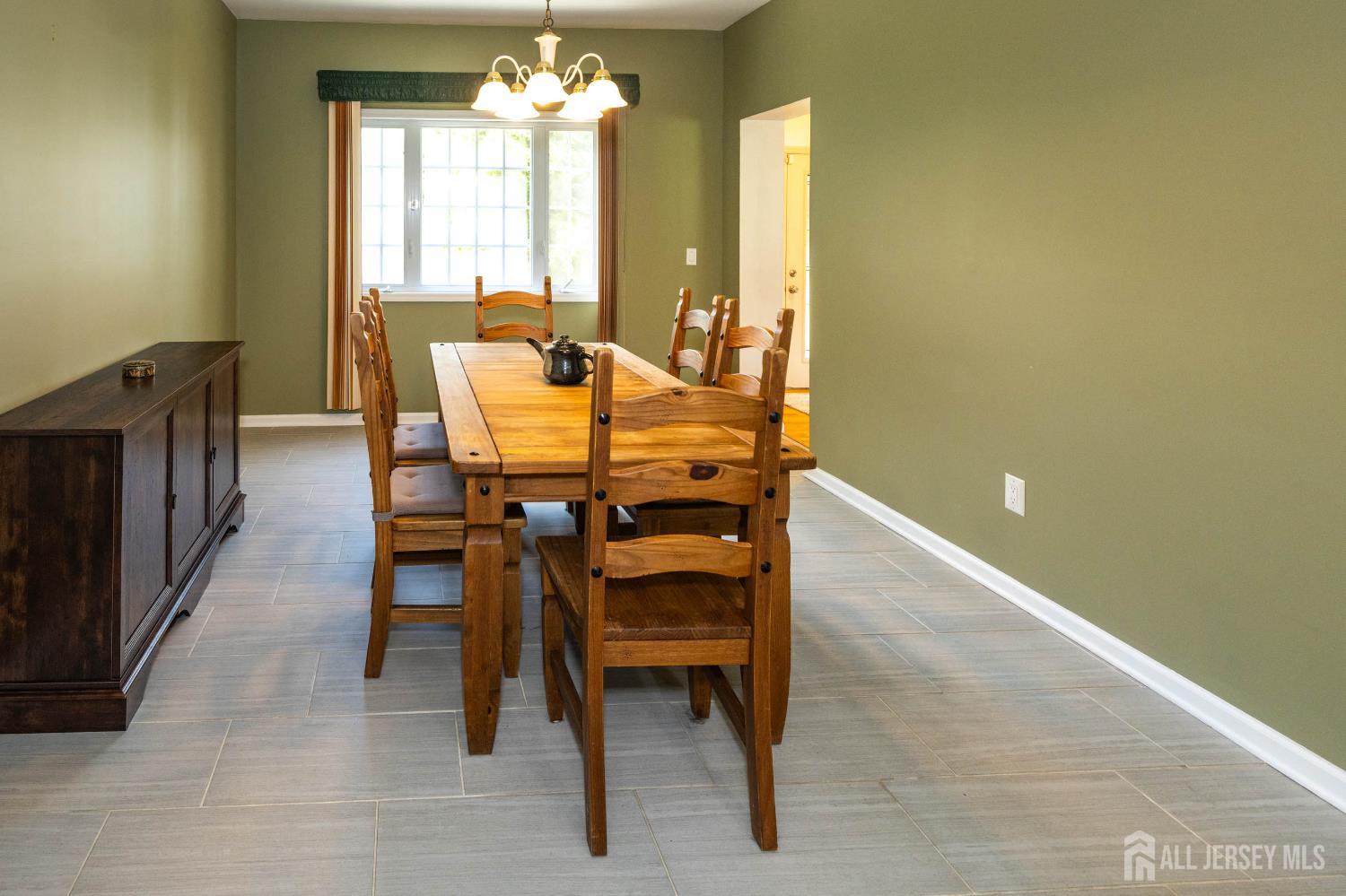 294 Fresh Ponds Road North Brunswick, NJ 08902 - Photo 18 of 53 a view of a dining room with furniture and a chandelier