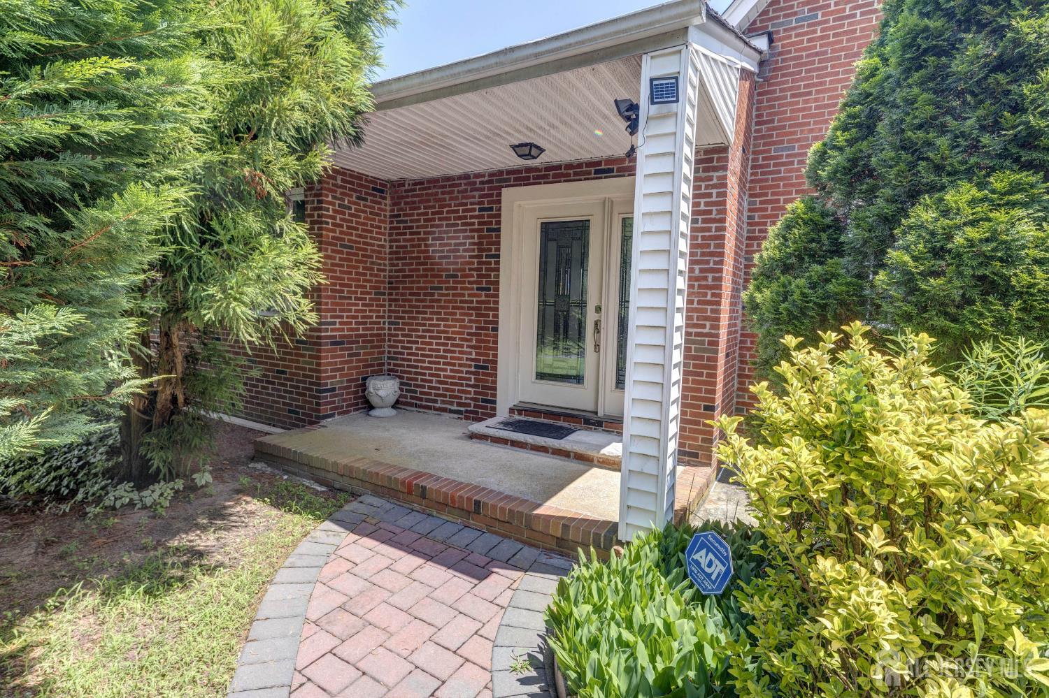 294 Fresh Ponds Road North Brunswick, NJ 08902 - Photo 2 of 53 a view of a brick house with a large windows and plants