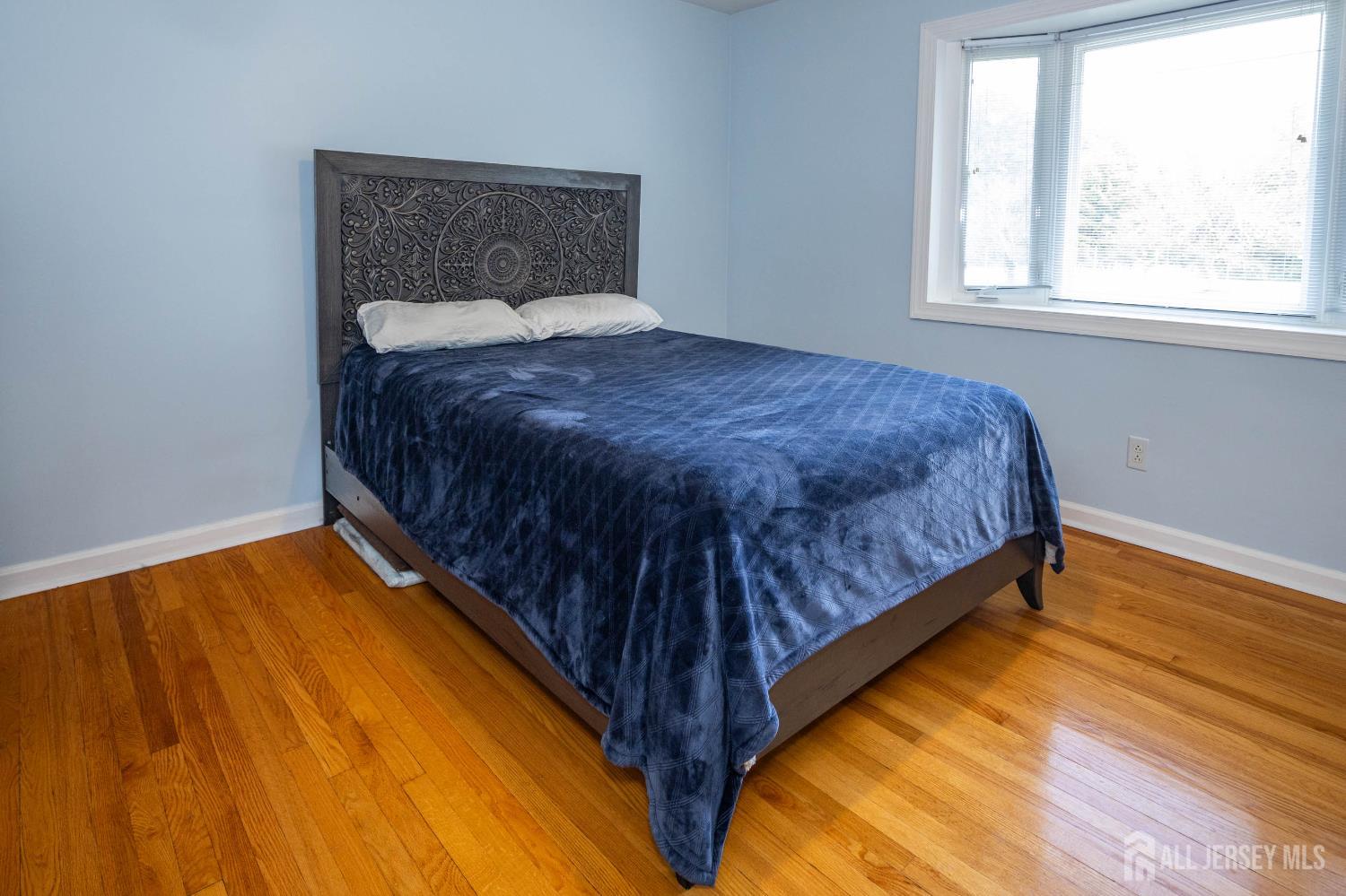 294 Fresh Ponds Road North Brunswick, NJ 08902 - Photo 21 of 53 a bed sitting in a bedroom next to a window