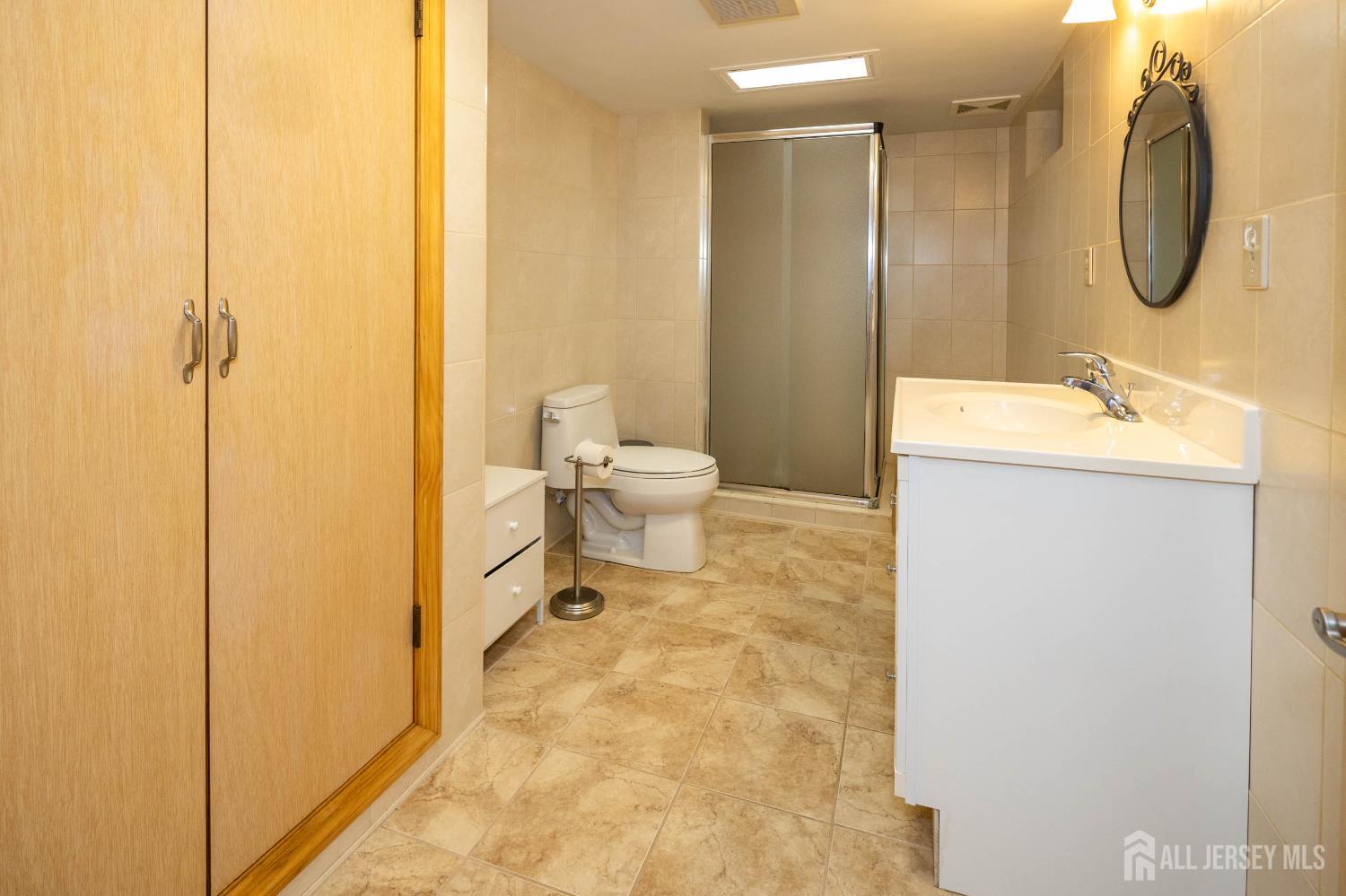 294 Fresh Ponds Road North Brunswick, NJ 08902 - Photo 28 of 53 a bathroom with a granite countertop sink toilet and shower
