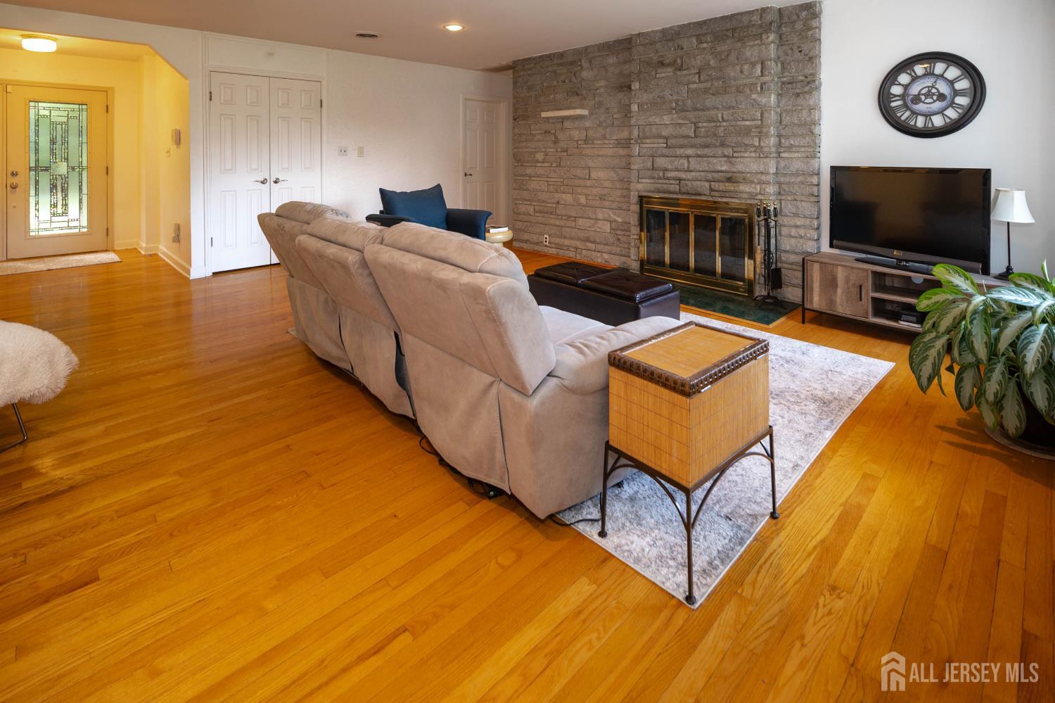 294 Fresh Ponds Road North Brunswick, NJ 08902 - Photo 7 of 53 a living room with furniture a flat screen tv and a fireplace