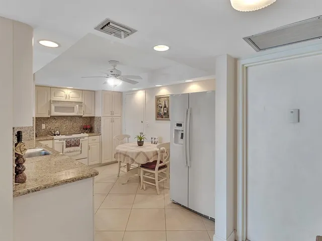 a kitchen with stainless steel appliances kitchen island granite countertop a sink and cabinets