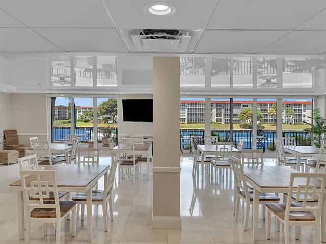 a kitchen with stainless steel appliances kitchen island granite countertop a table and chairs