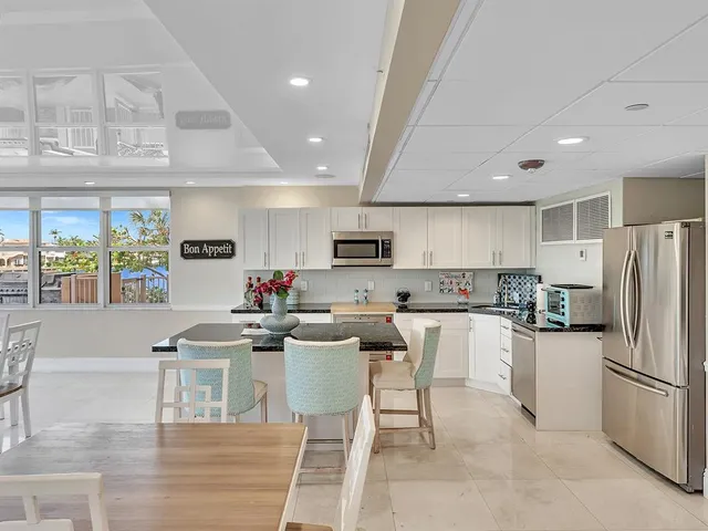a living room with furniture a table and a large window