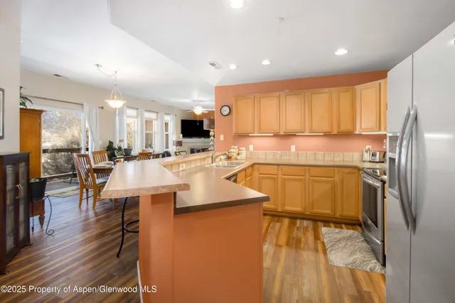 a kitchen with stainless steel appliances granite countertop a refrigerator sink and cabinets