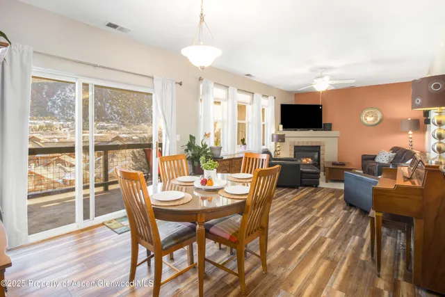 a view of a dining room with furniture window and wooden floor