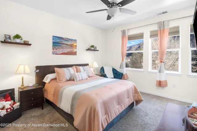 a bedroom with a large bed and a window