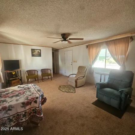a bedroom with bed couch and window