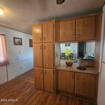 a kitchen with sink cabinets and wooden floor