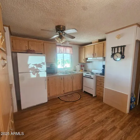 a kitchen with kitchen island a counter top space wooden floor and stainless steel appliances