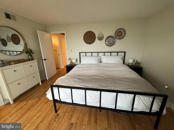 a bedroom with a bed and a dresser