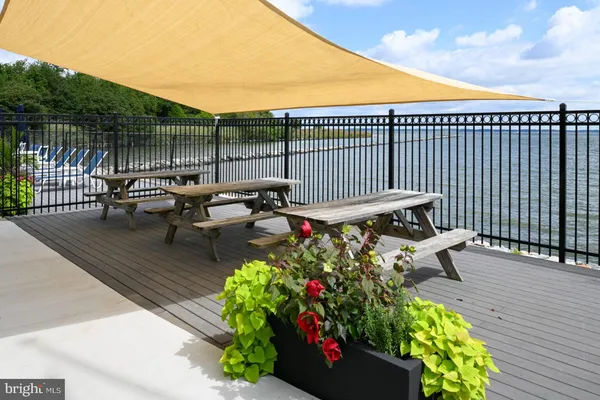 a view of a patio with couches table and chairs and potted plants