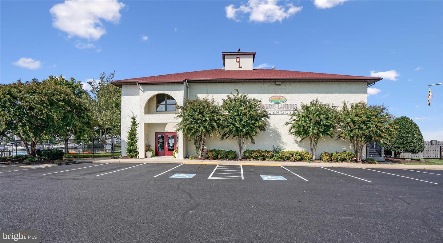 34 Queen Anne Way, Unit F Chester, MD 21619 - Photo 17 of 21 a front view of a house with a yard and a garage