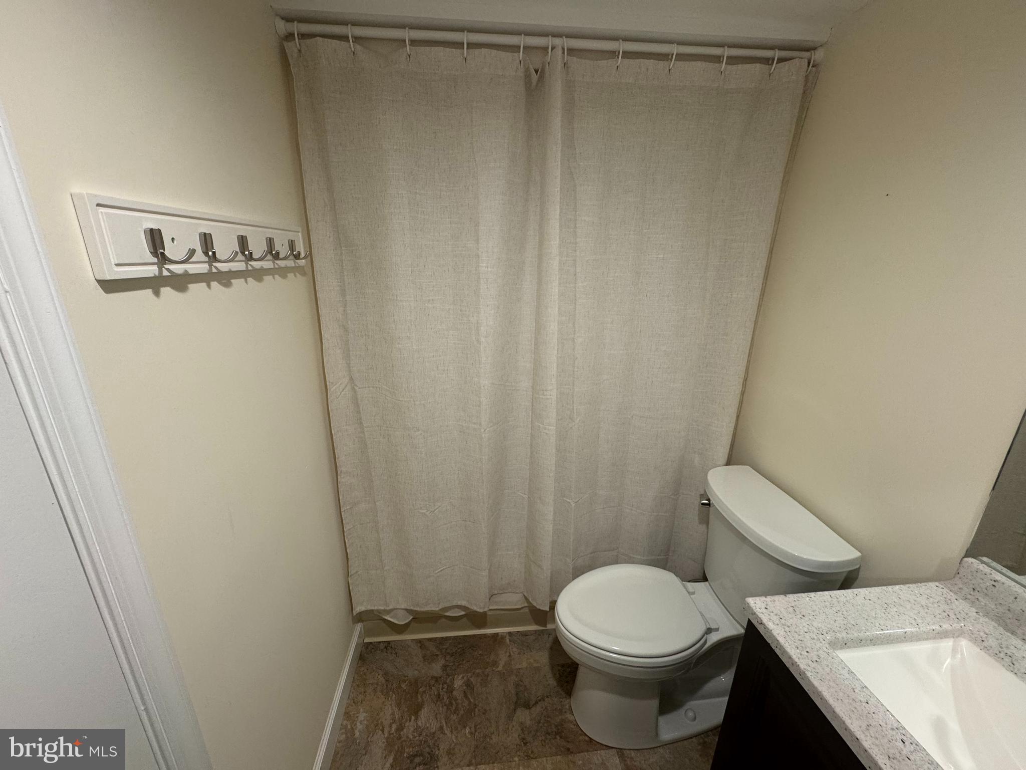 34 Queen Anne Way, Unit F Chester, MD 21619 - Photo 8 of 21 a white toilet sitting next to a shower