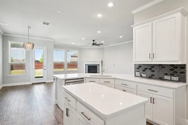 a kitchen with a sink stove and cabinets