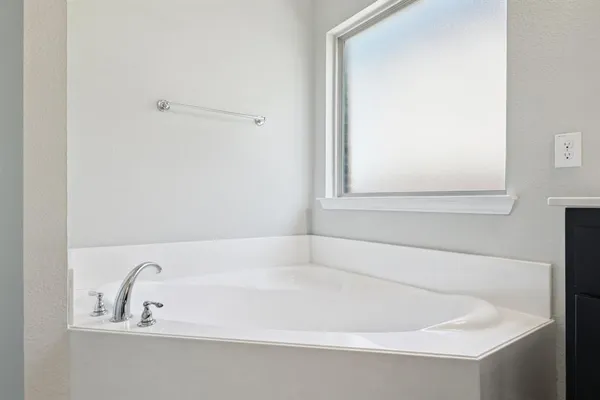 a white bath tub sitting next to a window