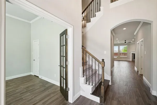 a view of a hallway with wooden floor and staircase