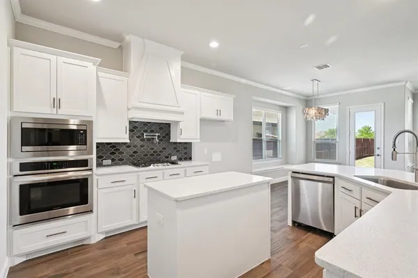 a kitchen with a sink stove and microwave