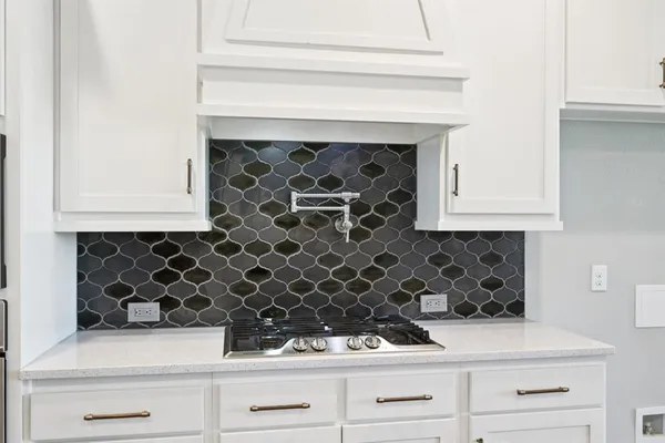 a close view of a stove a microwave and cabinets