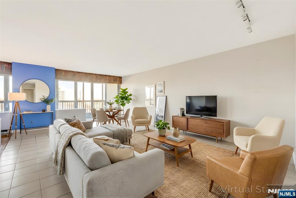 5 Horizon Road, Unit 907 Fort Lee, NJ 07024 - Photo 1 of 48 a living room with furniture and a flat screen tv