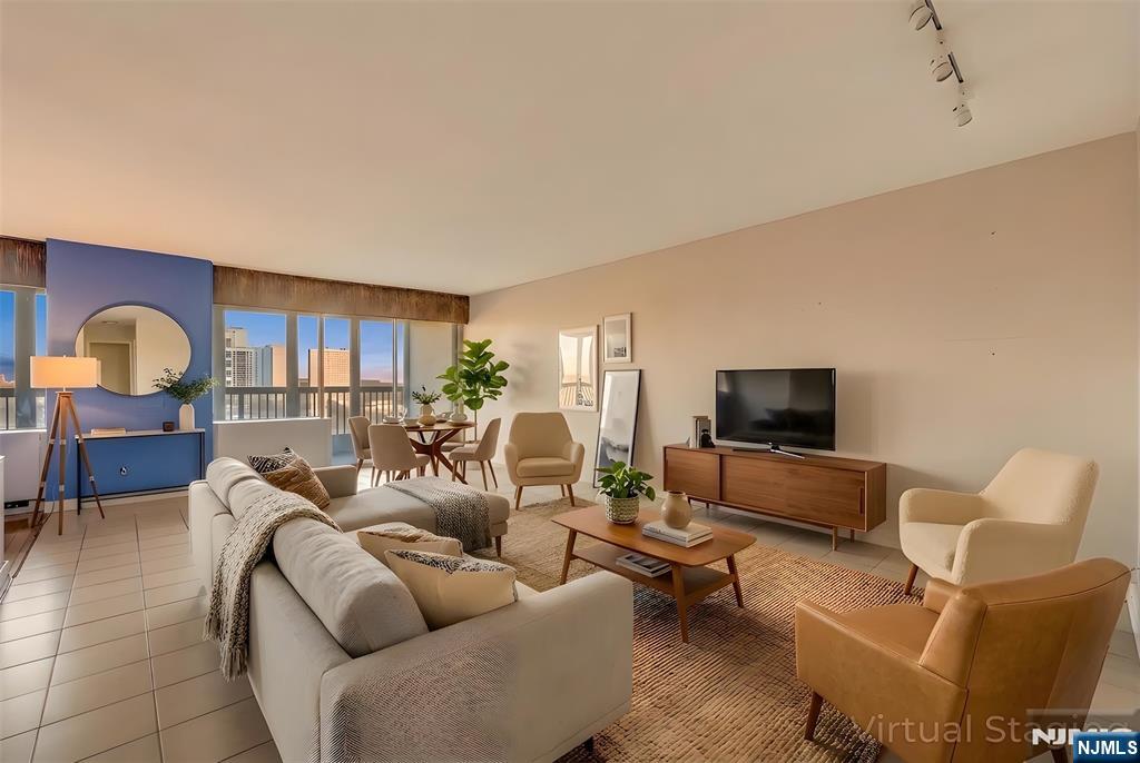 5 Horizon Road, Unit 907 Fort Lee, NJ 07024 - Photo 2 of 48 a living room with furniture and a flat screen tv