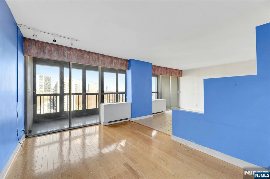 5 Horizon Road, Unit 907 Fort Lee, NJ 07024 - Photo 26 of 48 a view of empty room with wooden floor and fan