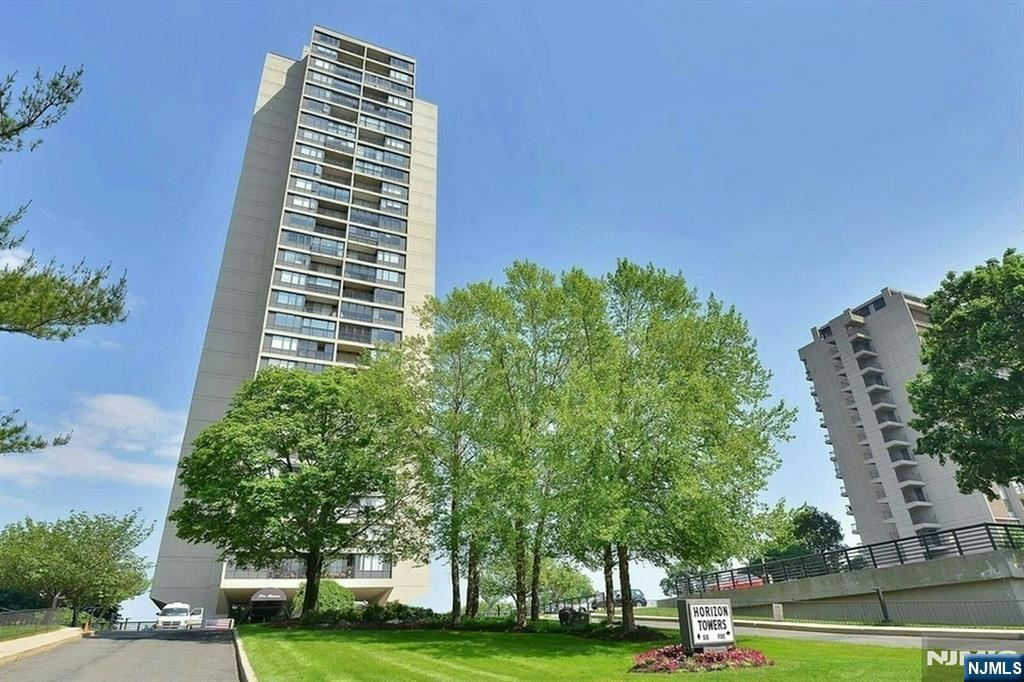 5 Horizon Road, Unit 907 Fort Lee, NJ 07024 - Photo 46 of 48 a view of a tall building next to a yard