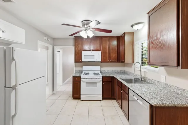 a kitchen with a sink appliances and cabinets