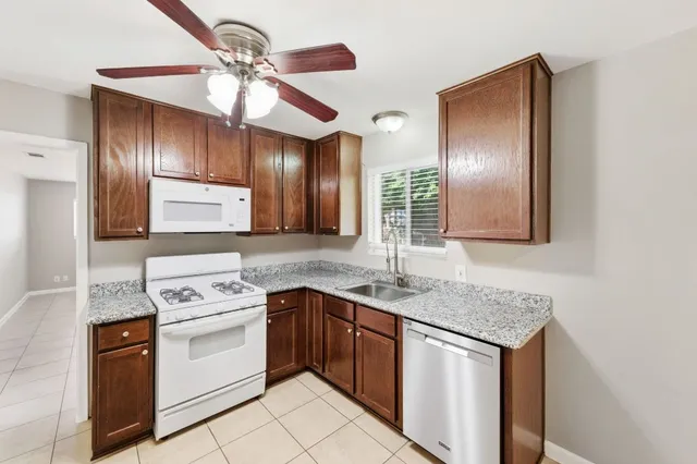 a kitchen with a stove cabinets and chandelier
