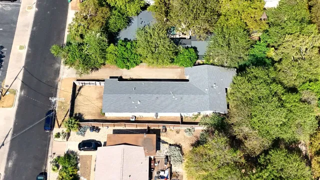 an aerial view of a house with a yard
