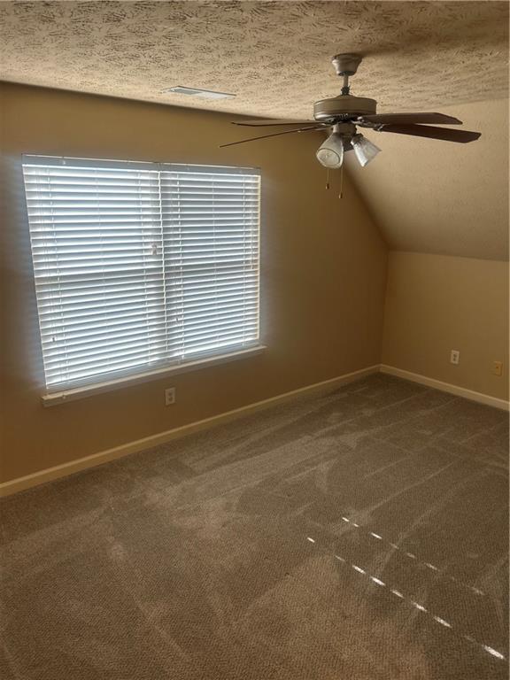 22 Pawnee Trail Fort Mitchell, AL 36856 - Photo 26 of 40 Sloped ceiling room featuring a window with blinds, ceiling fan with integrated lighting, and carpeted flooring
