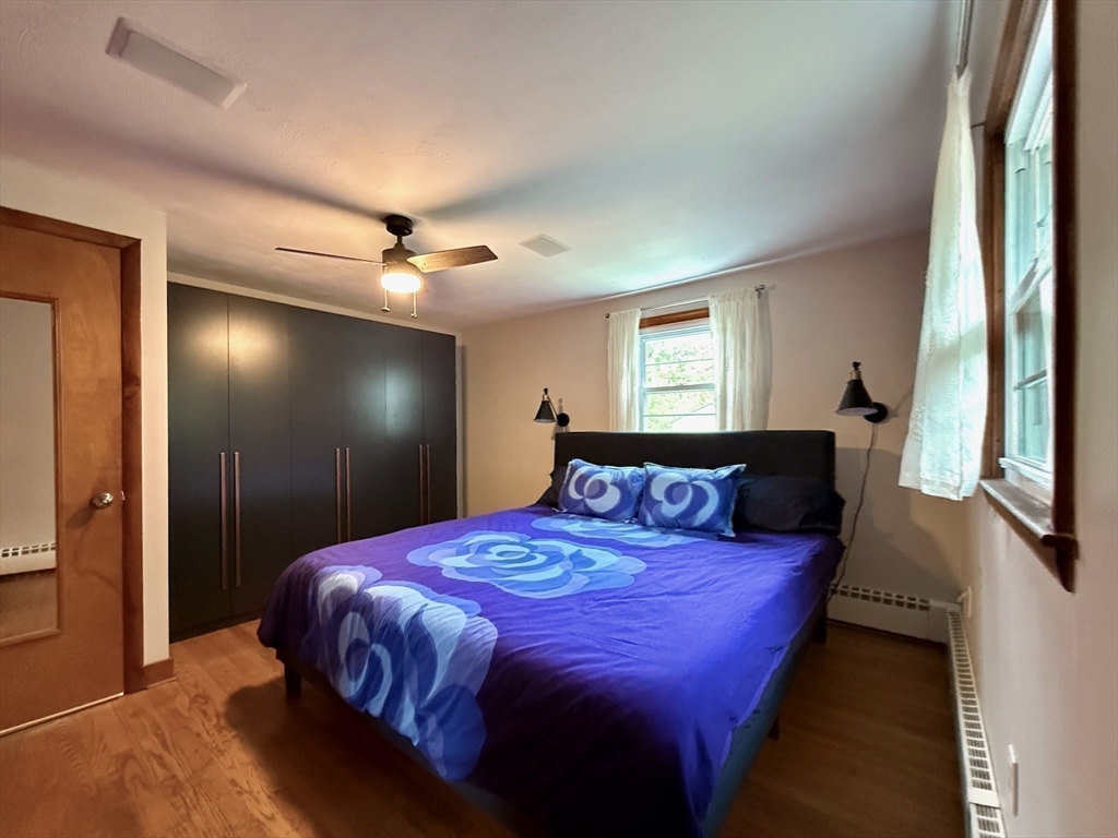 102 Bridge Road Northampton, MA 01062 - Photo 13 of 34 a bedroom with a bed and a chandelier