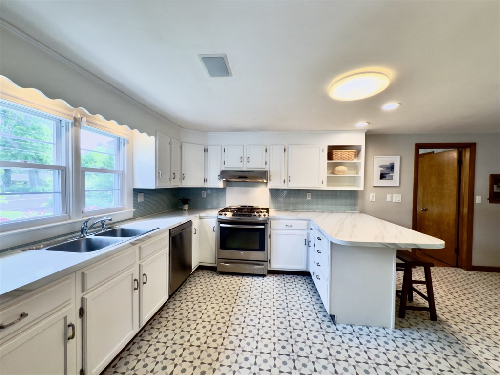 102 Bridge Road Northampton, MA 01062 - Photo 4 of 34 a kitchen with a sink stove and cabinets