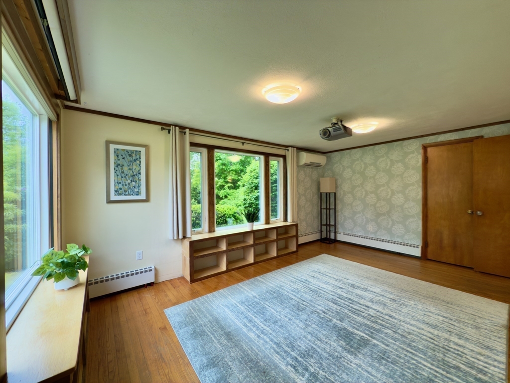 102 Bridge Road Northampton, MA 01062 - Photo 7 of 34 a view of an empty room with wooden floor and a window