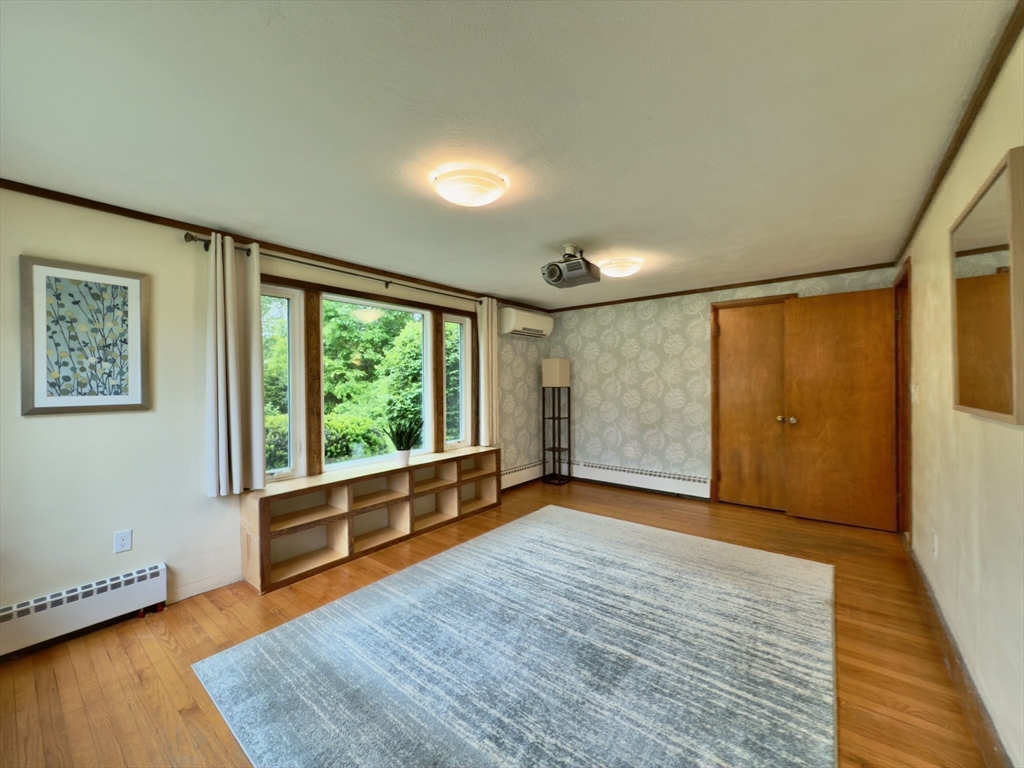 102 Bridge Road Northampton, MA 01062 - Photo 8 of 34 a view of an empty room with glass door and wooden floor