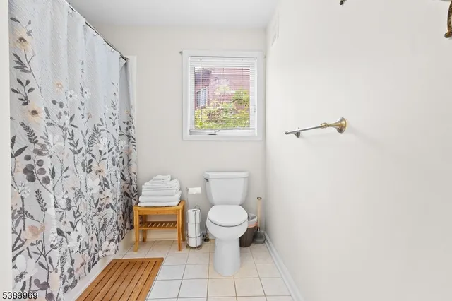 a white toilet sitting next to a shower curtain