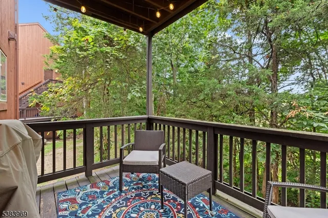 a view of a two chairs in the balcony
