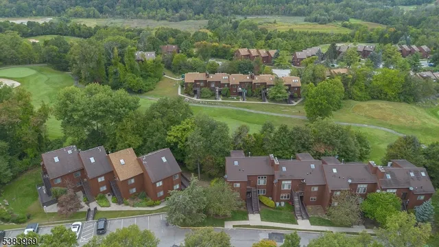 an aerial view of a house with a garden and lake view