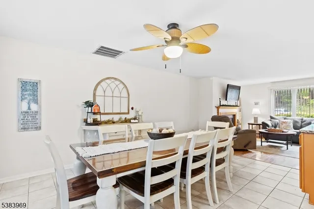 a view of a dining room with furniture and chandelier