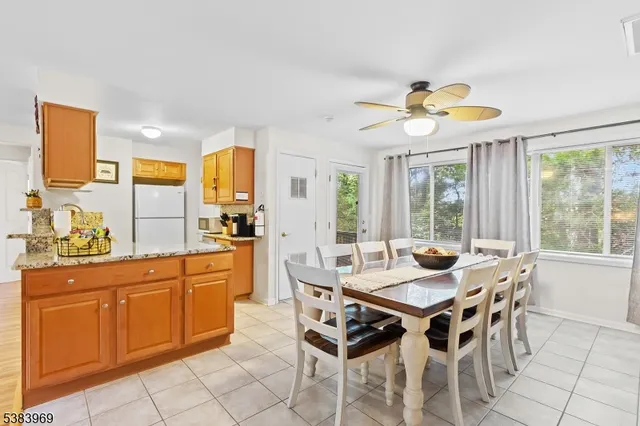 a view of a dining room with furniture a chandelier and wooden floor